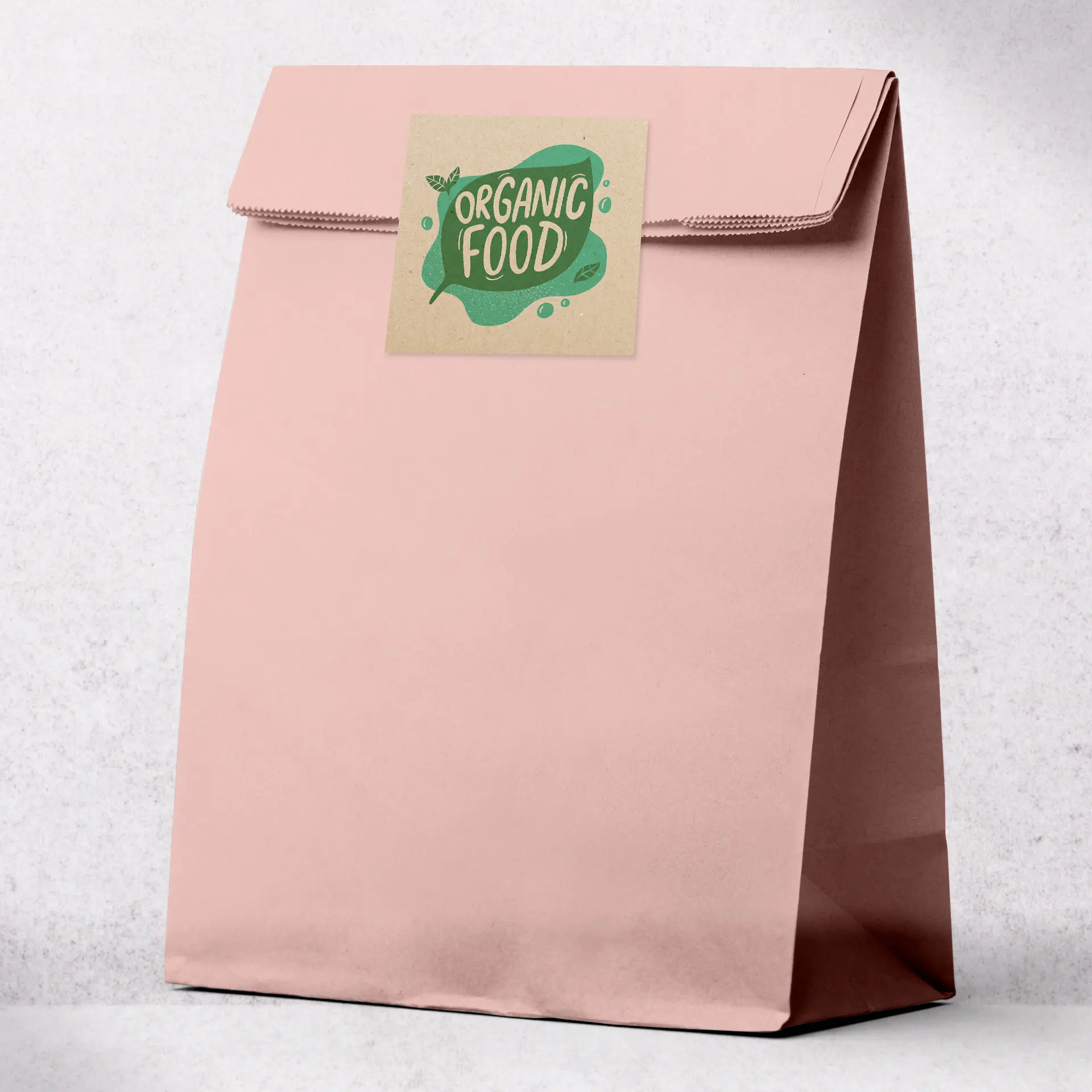 Borsa in carta kraft rosa con etichetta quadrata che presenta il testo "Cibo Biologico" e elementi decorativi.
