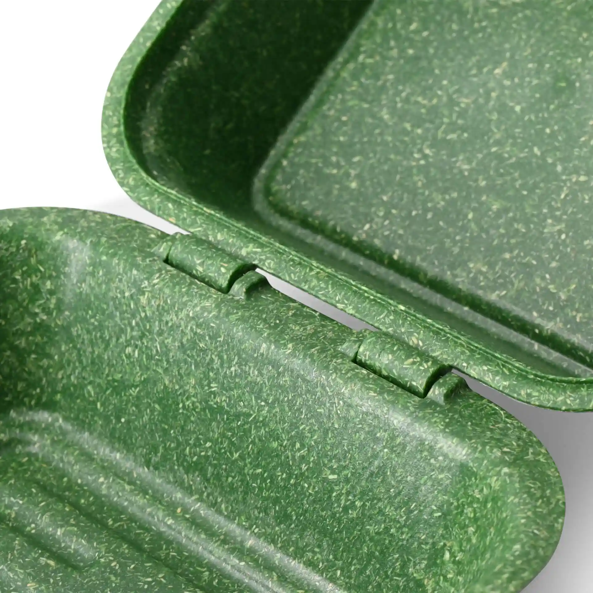 Scatola per hamburger riutilizzabile verde aperta con superficie testurizzata, che mostra l'interno e il meccanismo della cerniera.